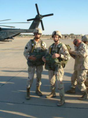 ODS Jump ODA-914 
On Compass Rose Ali Al Slaeem AB Kuwait Dec 2002 SSG Ben Cantu watching as MSG James McMahan giving CPT Argot Carberry JM check
